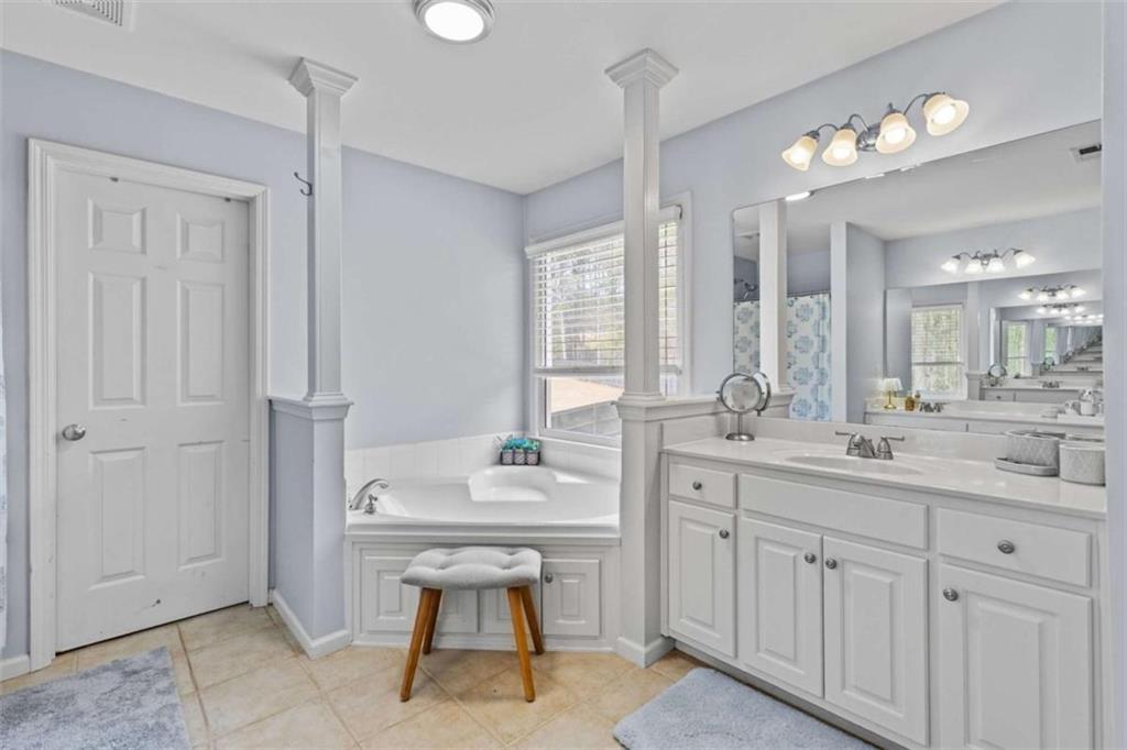 1148 Maple Creek Ridge Loganville, GA 30052 - Photo 33 of 46 a bathroom with a sink a toilet a large mirror and shower