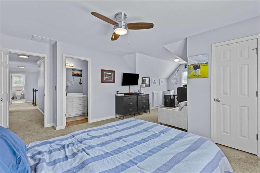 1148 Maple Creek Ridge Loganville, GA 30052 - Photo 35 of 46 a bedroom with a bed and a flat screen tv