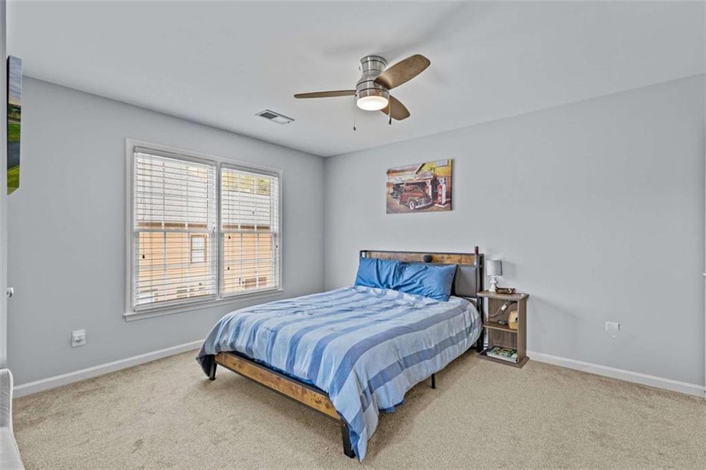 1148 Maple Creek Ridge Loganville, GA 30052 - Photo 36 of 46 a bedroom with a bed and window