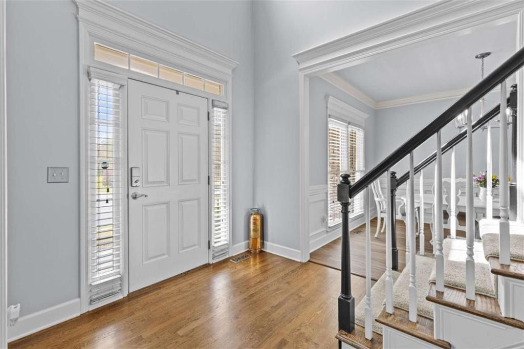 1148 Maple Creek Ridge Loganville, GA 30052 - Photo 4 of 46 a view of an entryway with wooden floor