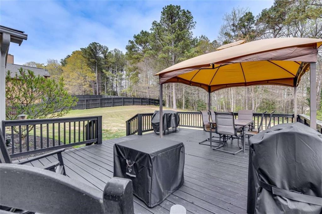 1148 Maple Creek Ridge Loganville, GA 30052 - Photo 43 of 46 an outdoor space with furniture and umbrella