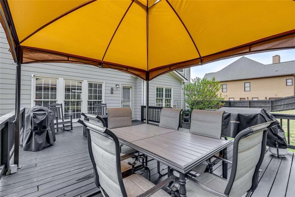 1148 Maple Creek Ridge Loganville, GA 30052 - Photo 44 of 46 a view of a dinning table and chairs in the patio