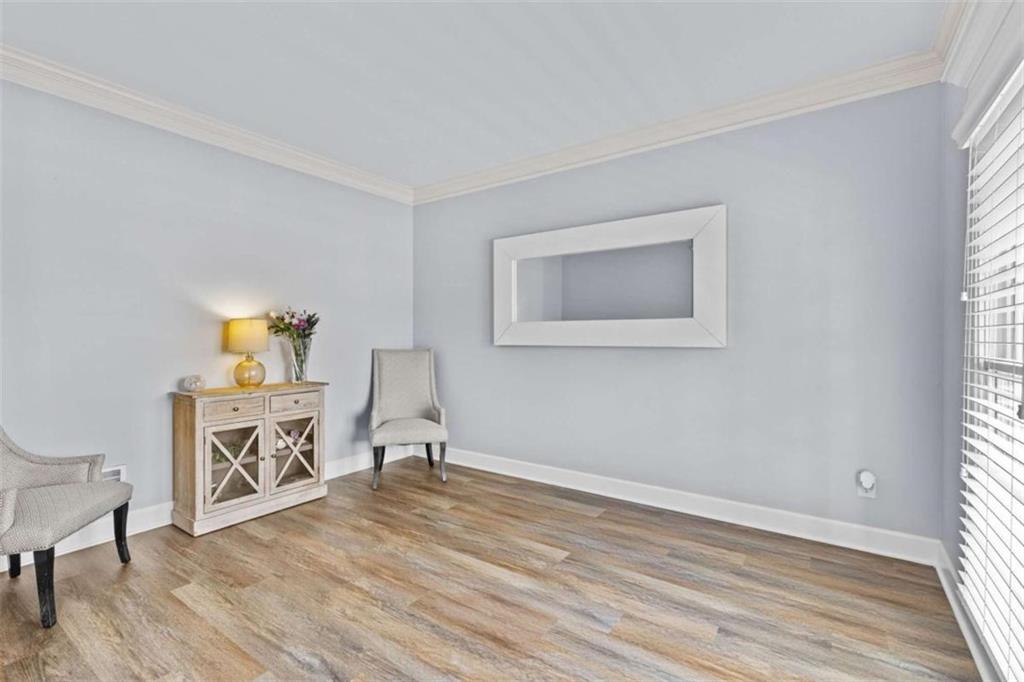 1148 Maple Creek Ridge Loganville, GA 30052 - Photo 5 of 46 a view of a livingroom with wooden floor and a window