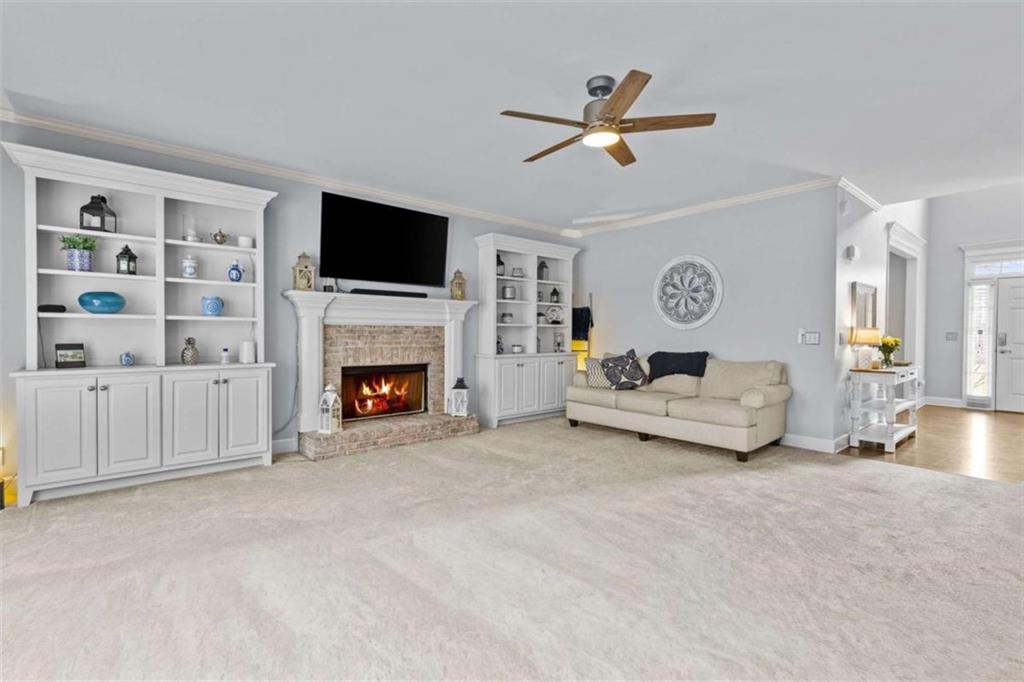1148 Maple Creek Ridge Loganville, GA 30052 - Photo 10 of 46 a living room with furniture and a fireplace