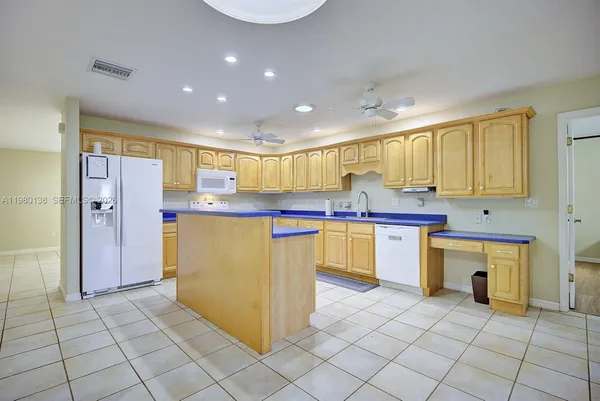 a kitchen with a sink a stove cabinets and refrigerator