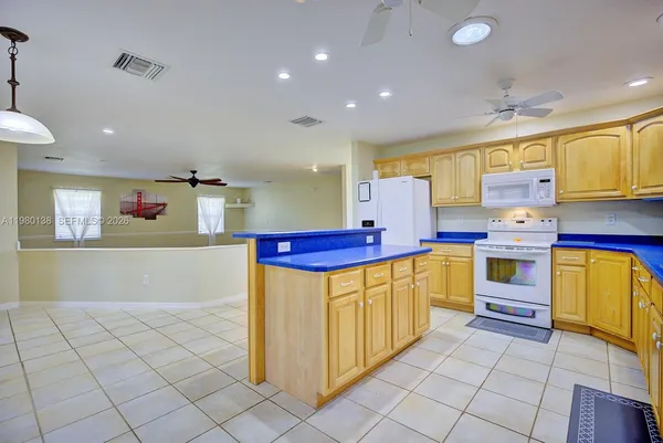 a kitchen with stainless steel appliances granite countertop a sink counter space cabinets and a stove