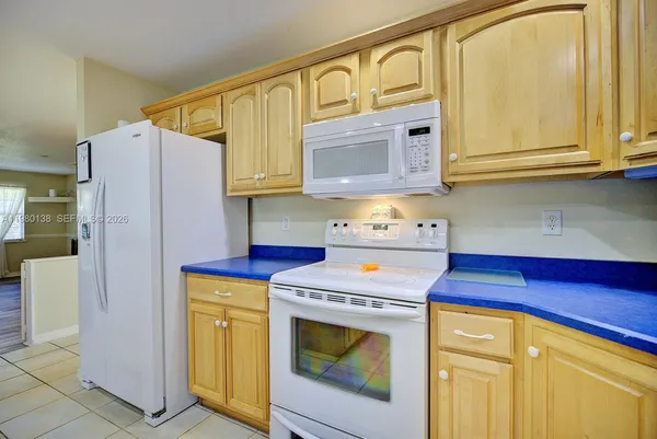 a kitchen with a refrigerator a stove and a microwave