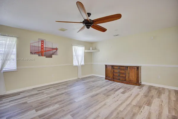 wooden floor in an empty room with a window