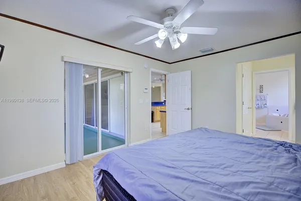 a bedroom with a large bed and chandelier