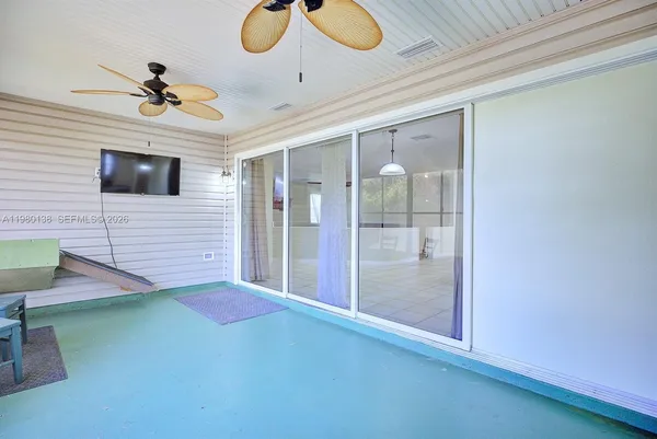 a view of a livingroom with furniture and chandelier fan