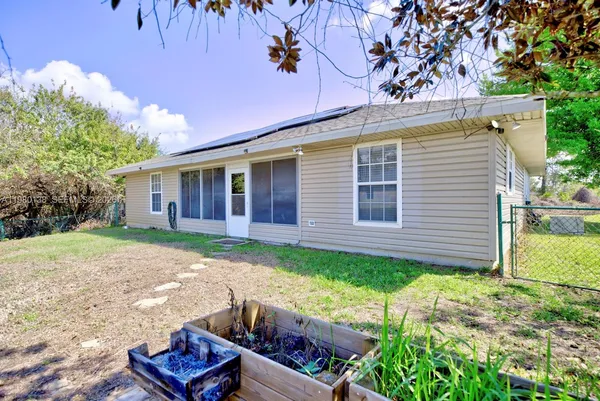 a view of a house with a yard and a garden