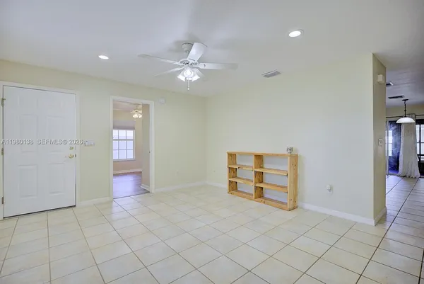 an empty room with closet and fan