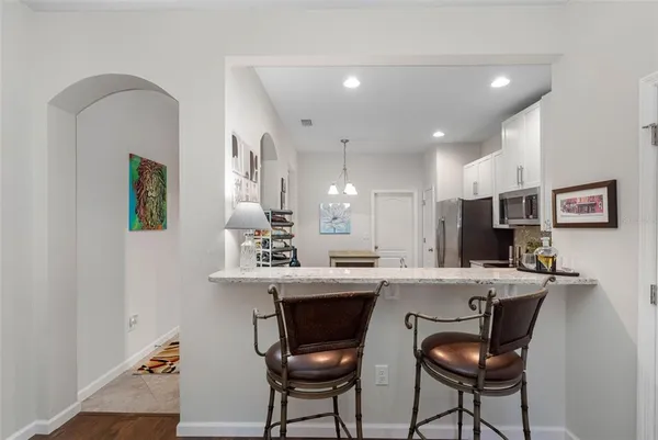 a living room with furniture a ceiling fan and a window