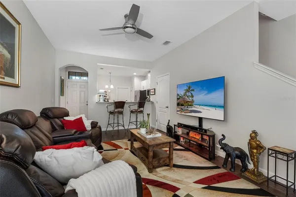 a living room with furniture and wooden floor
