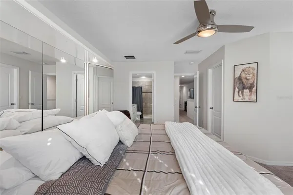 a bedroom with a bed and a chandelier