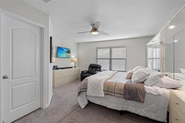 a bathroom with a granite countertop sink a toilet and a large mirror