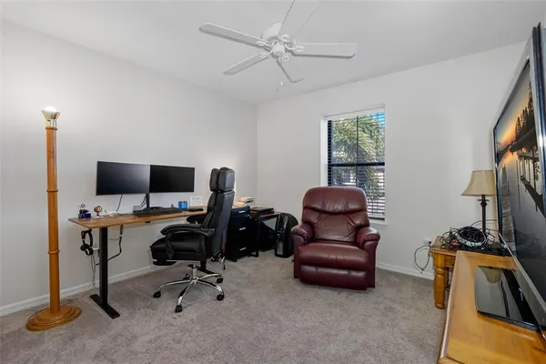 a view of a livingroom with workspace and a couch