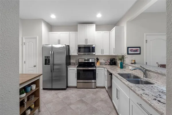 a kitchen with a sink stove and refrigerator