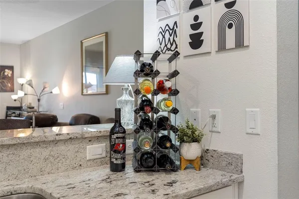 a kitchen with stainless steel appliances granite countertop white cabinets and a stove