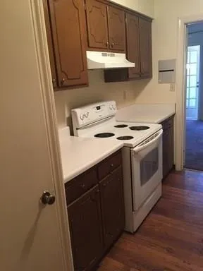 a kitchen with a stove sink and cabinets