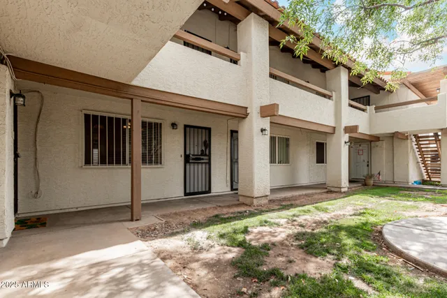 a view of a house with backyard and the trees