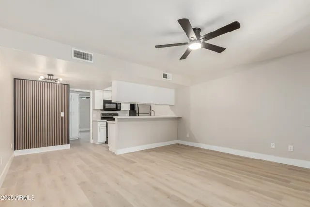 a view of a kitchen with a sink and dishwasher a refrigerator with wooden floor