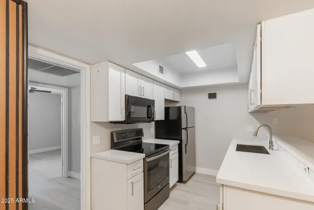 a kitchen with a sink a stove and refrigerator