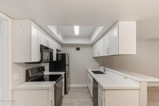 a kitchen with a sink a stove and refrigerator