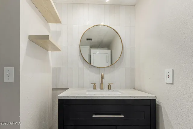 a bathroom with a sink and a mirror
