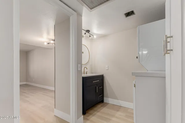 a bathroom with a sink a mirror and a shower