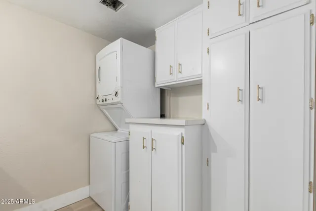 a view of cabinets and utility room with wooden floor