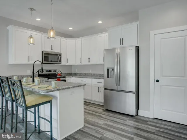 a kitchen with stainless steel appliances a refrigerator stove microwave and sink