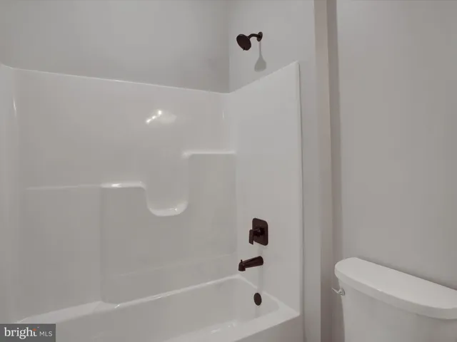 a bathroom with a bathtub and toilet