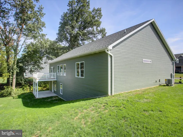 a view of an house with backyard space and garden
