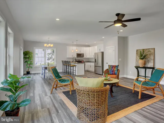 a living room with dining room and wooden floor