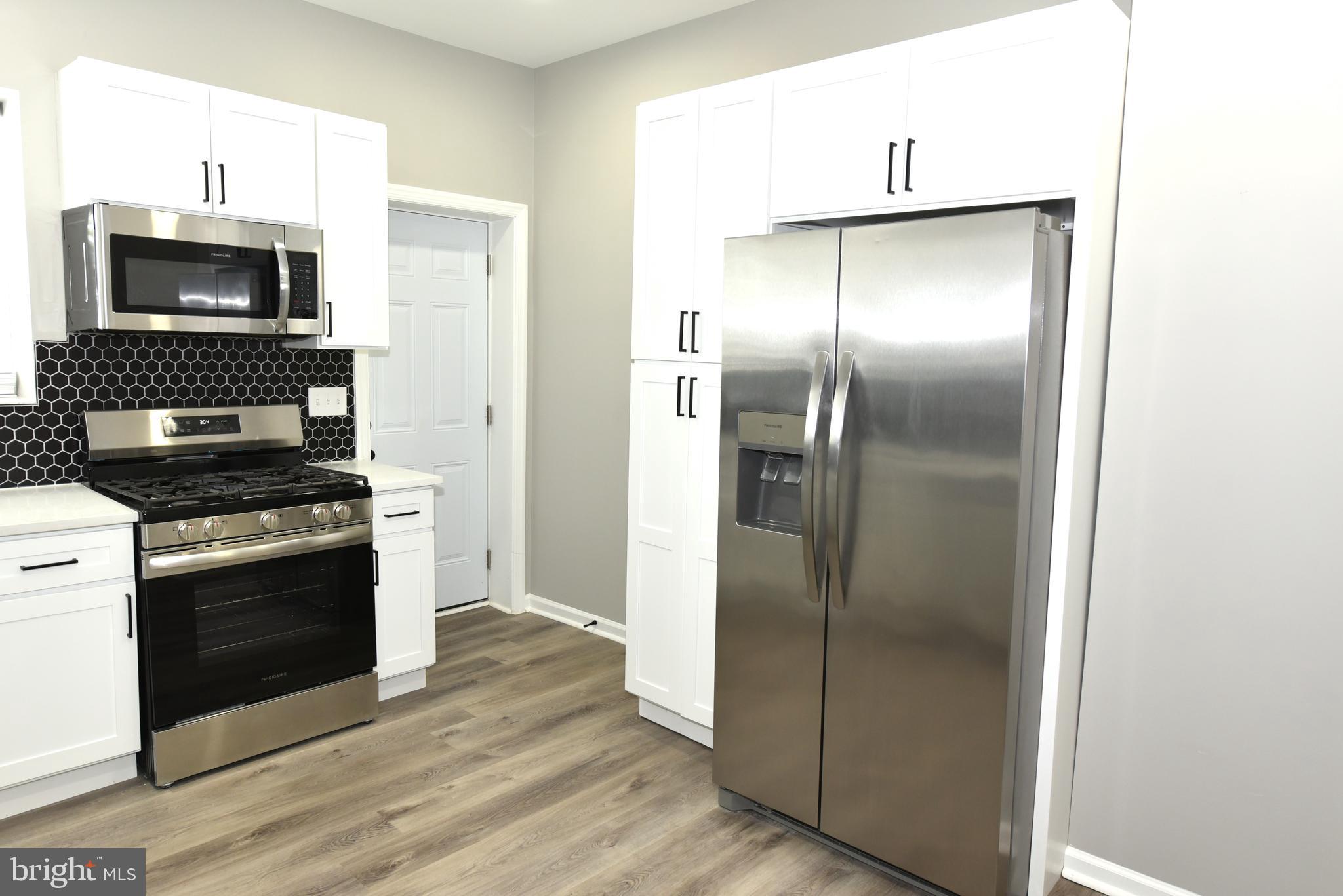 2225 West Baltimore Street Baltimore, MD 21223 - Photo 11 of 46 a kitchen with a refrigerator an oven and a sink