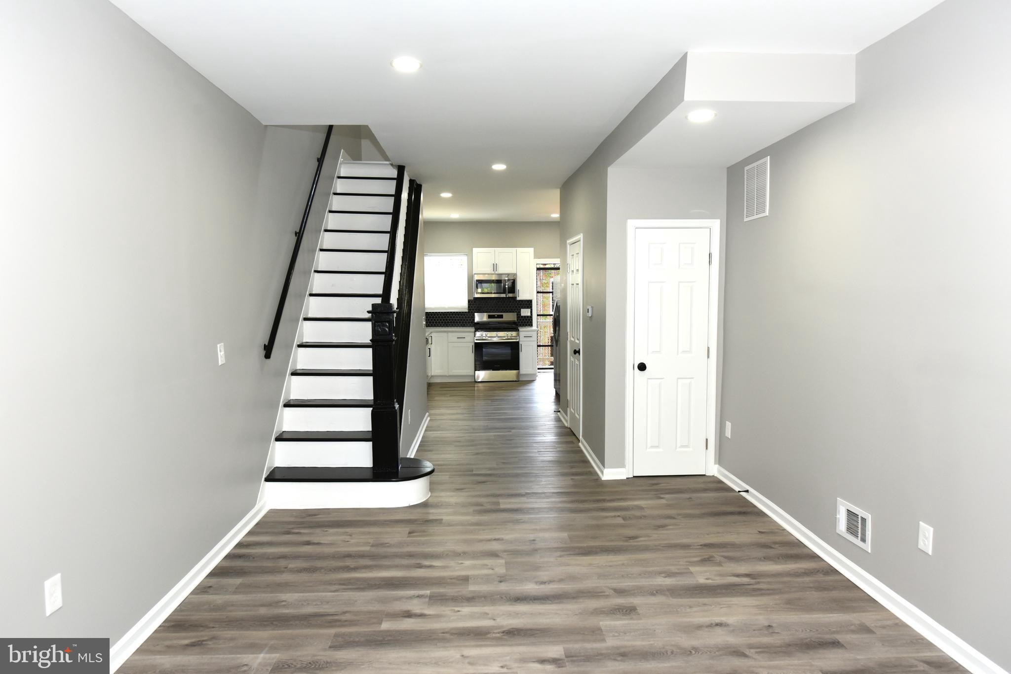 2225 West Baltimore Street Baltimore, MD 21223 - Photo 2 of 46 a view of a kitchen with wooden floor and stairs