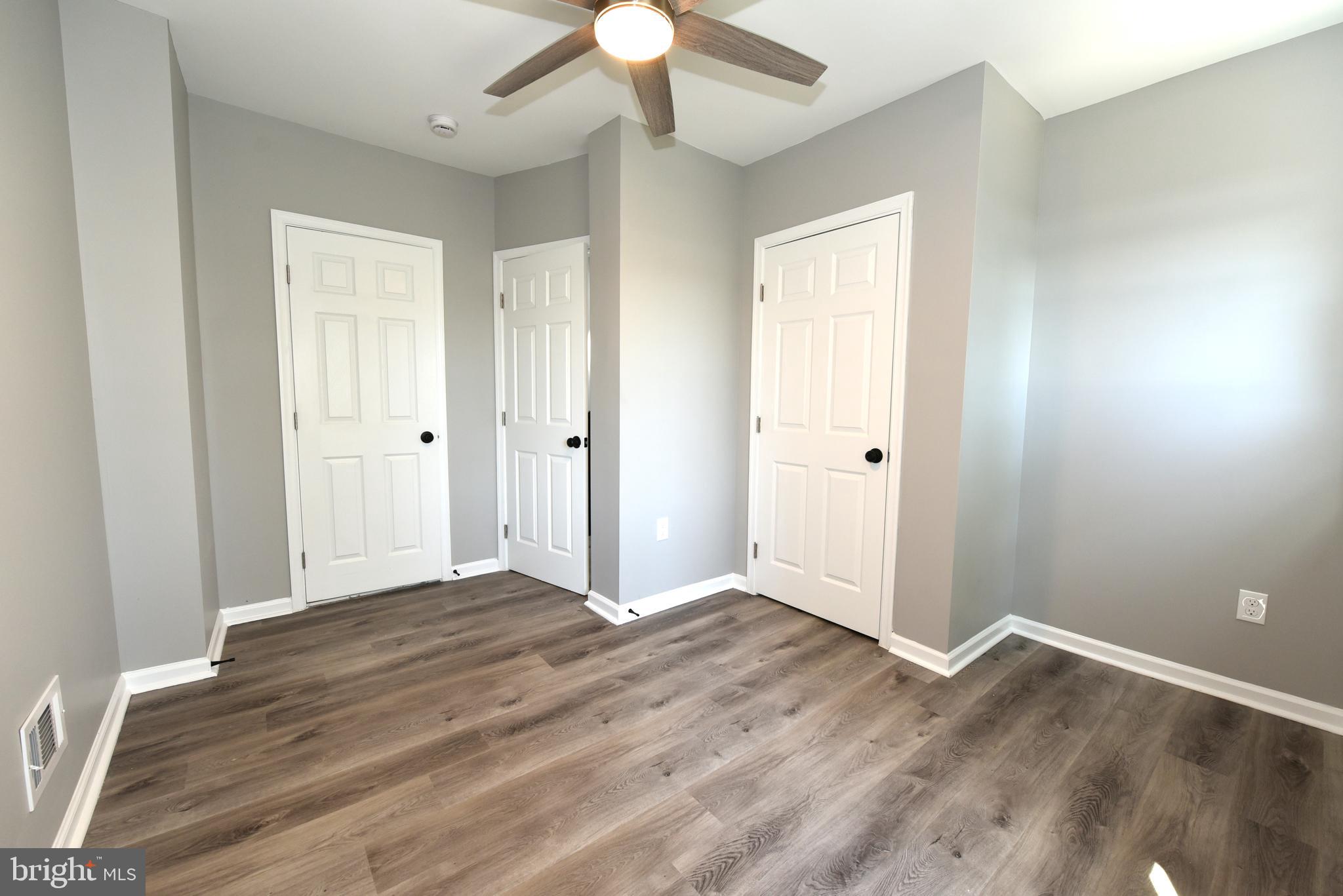 2225 West Baltimore Street Baltimore, MD 21223 - Photo 22 of 46 a view of an empty room with wooden floor