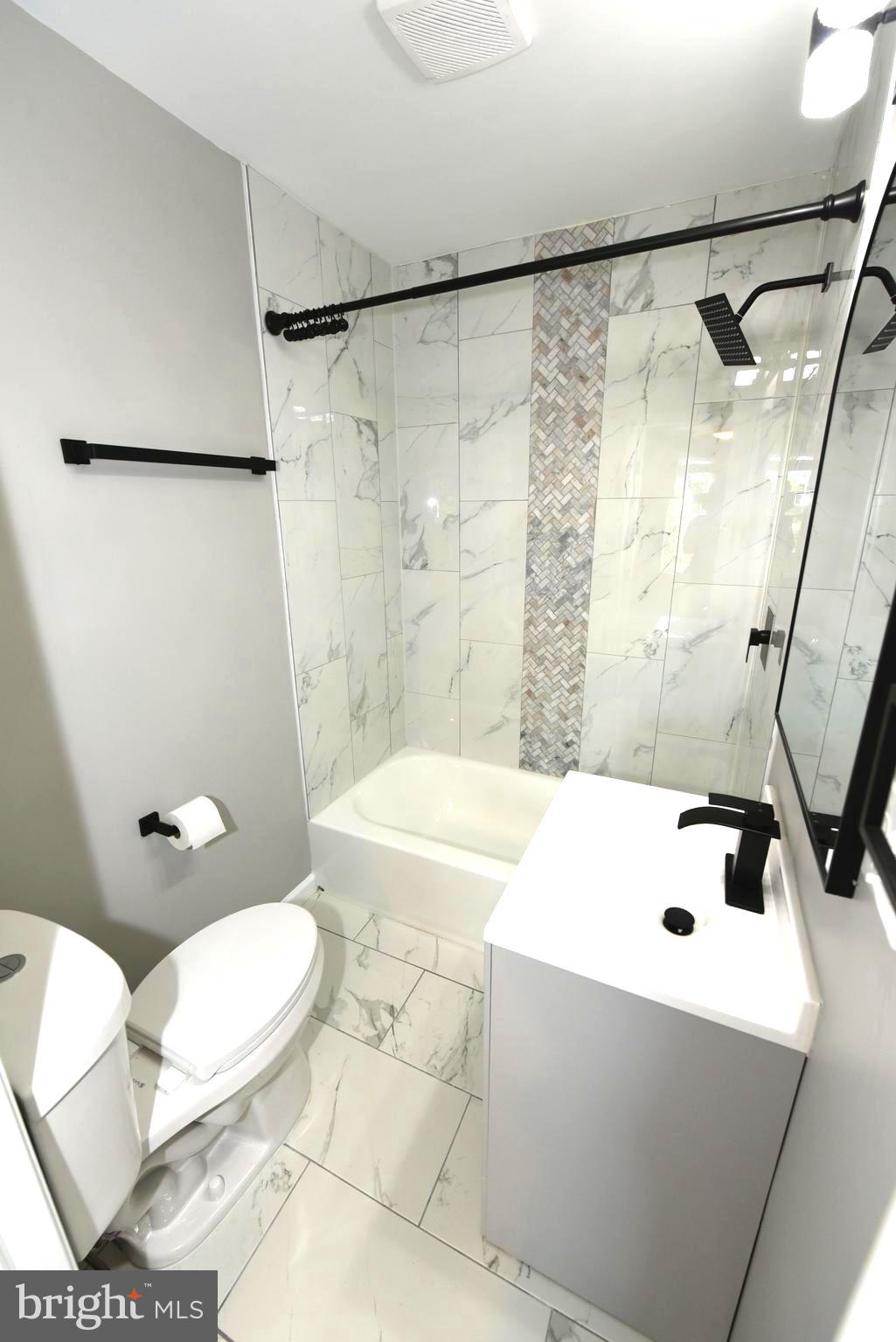 2225 West Baltimore Street Baltimore, MD 21223 - Photo 23 of 46 a bathroom with a sink a toilet and a shower