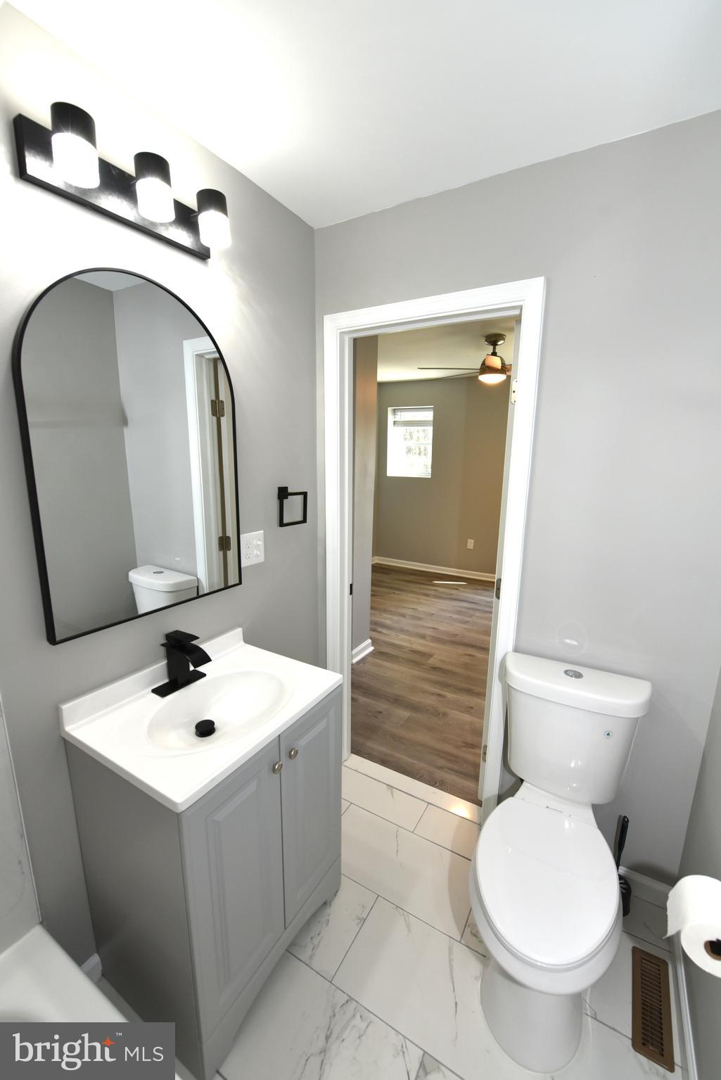 2225 West Baltimore Street Baltimore, MD 21223 - Photo 24 of 46 a bathroom with a toilet sink and mirror