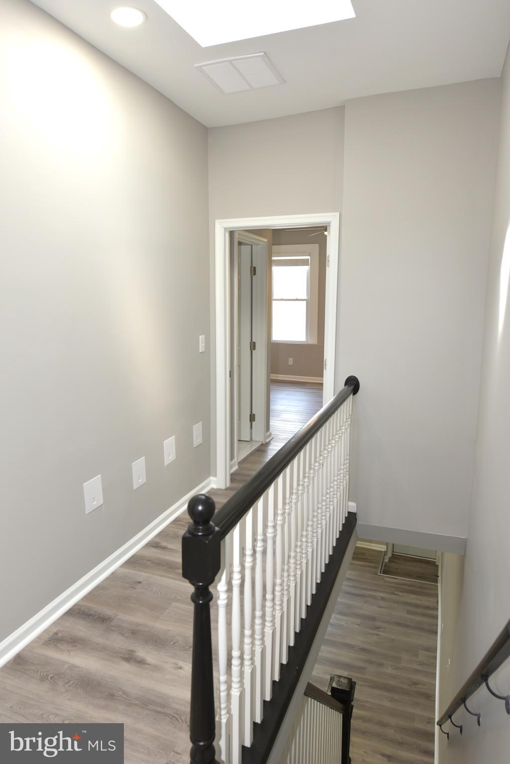 2225 West Baltimore Street Baltimore, MD 21223 - Photo 25 of 46 a view of a hallway with wooden floor and staircase