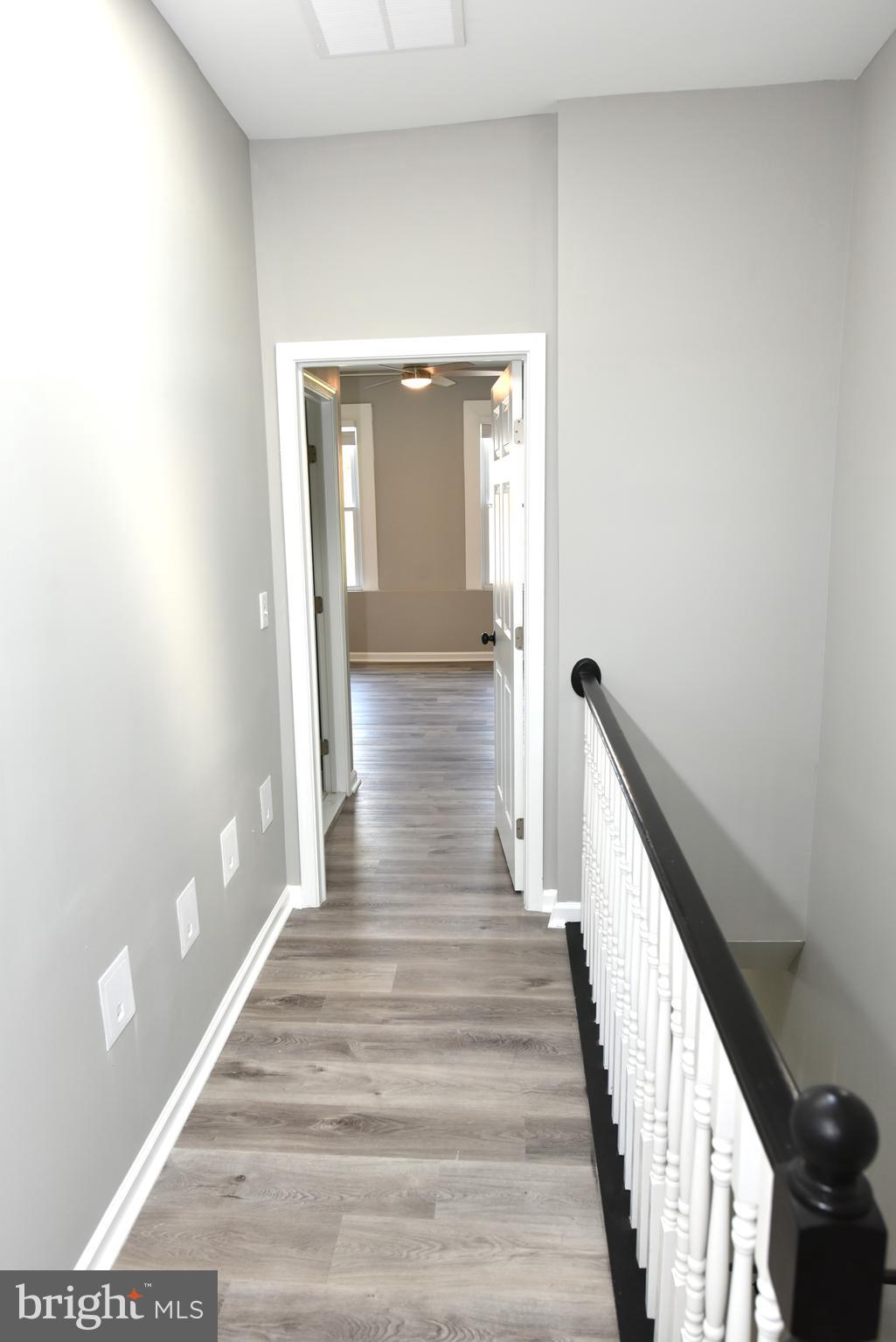 2225 West Baltimore Street Baltimore, MD 21223 - Photo 26 of 46 a view of a hallway with wooden floor and staircase