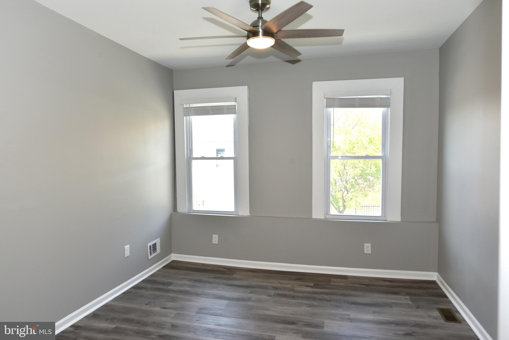 2225 West Baltimore Street Baltimore, MD 21223 - Photo 27 of 46 an empty room with window and a ceiling fan