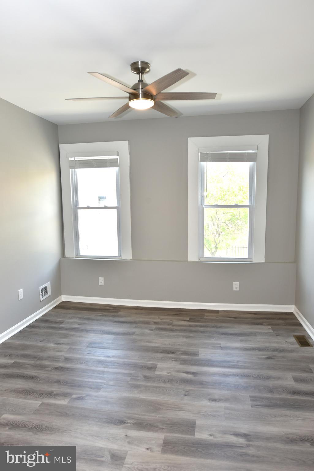 2225 West Baltimore Street Baltimore, MD 21223 - Photo 28 of 46 a view of an empty room with wooden floor and a window