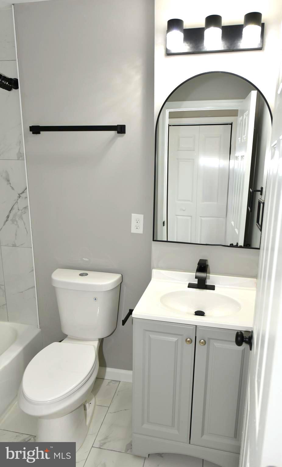 2225 West Baltimore Street Baltimore, MD 21223 - Photo 32 of 46 a bathroom with a toilet sink and mirror