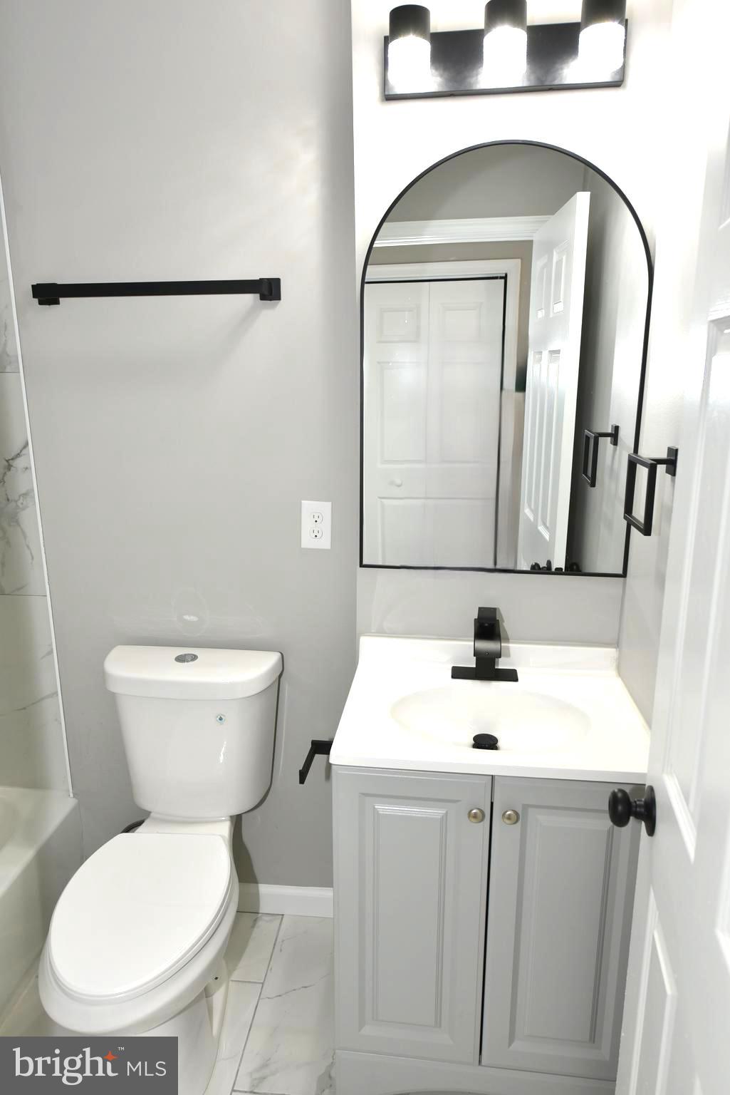 2225 West Baltimore Street Baltimore, MD 21223 - Photo 33 of 46 a bathroom with a toilet sink and mirror