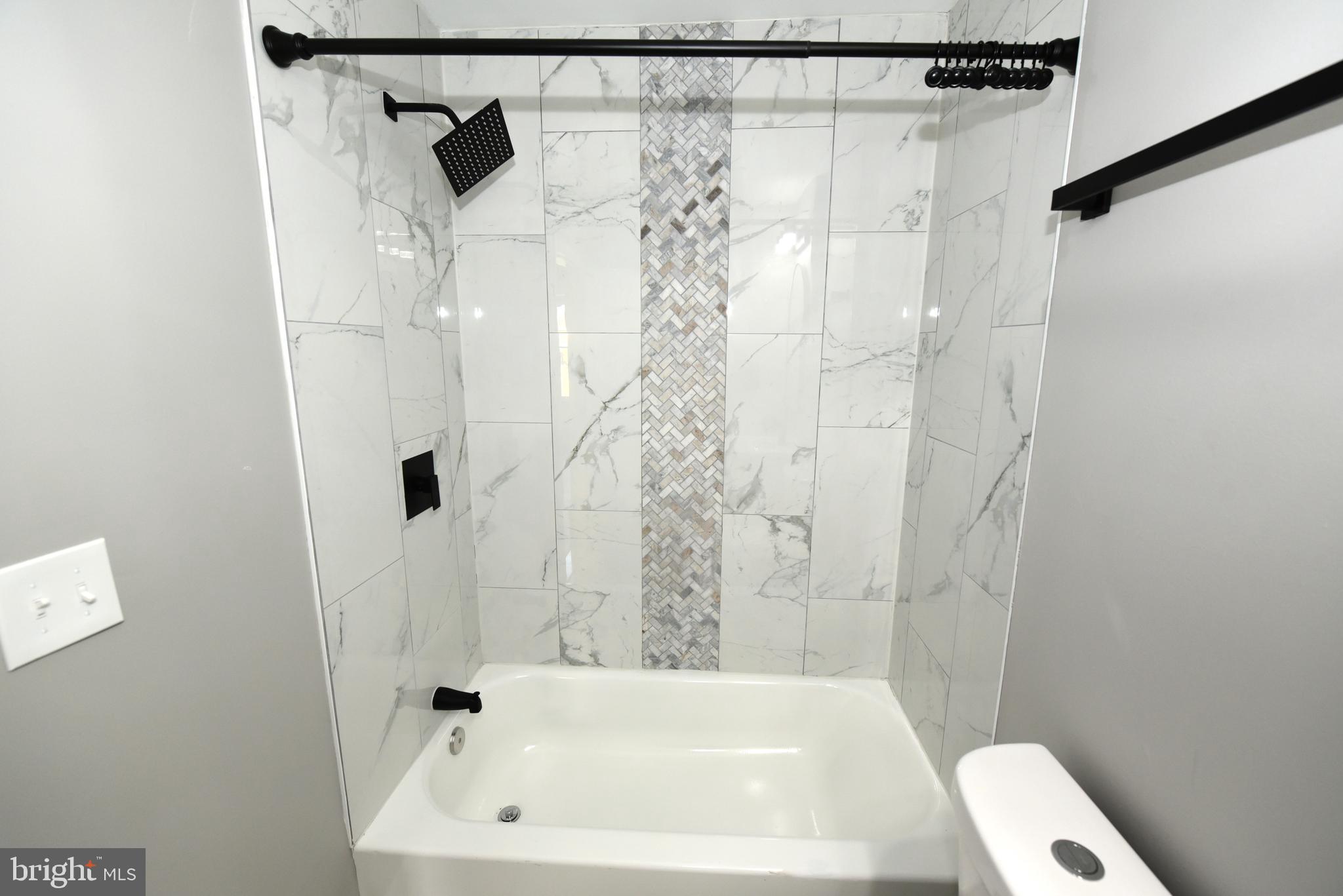 2225 West Baltimore Street Baltimore, MD 21223 - Photo 34 of 46 a bathroom with a shower and a sink