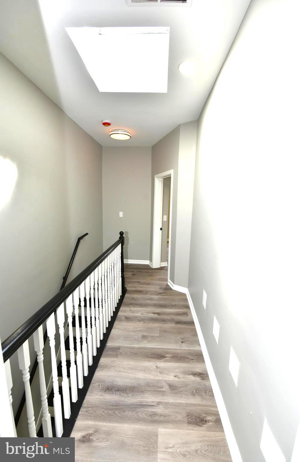 2225 West Baltimore Street Baltimore, MD 21223 - Photo 36 of 46 a view of a hallway with wooden floor and staircase