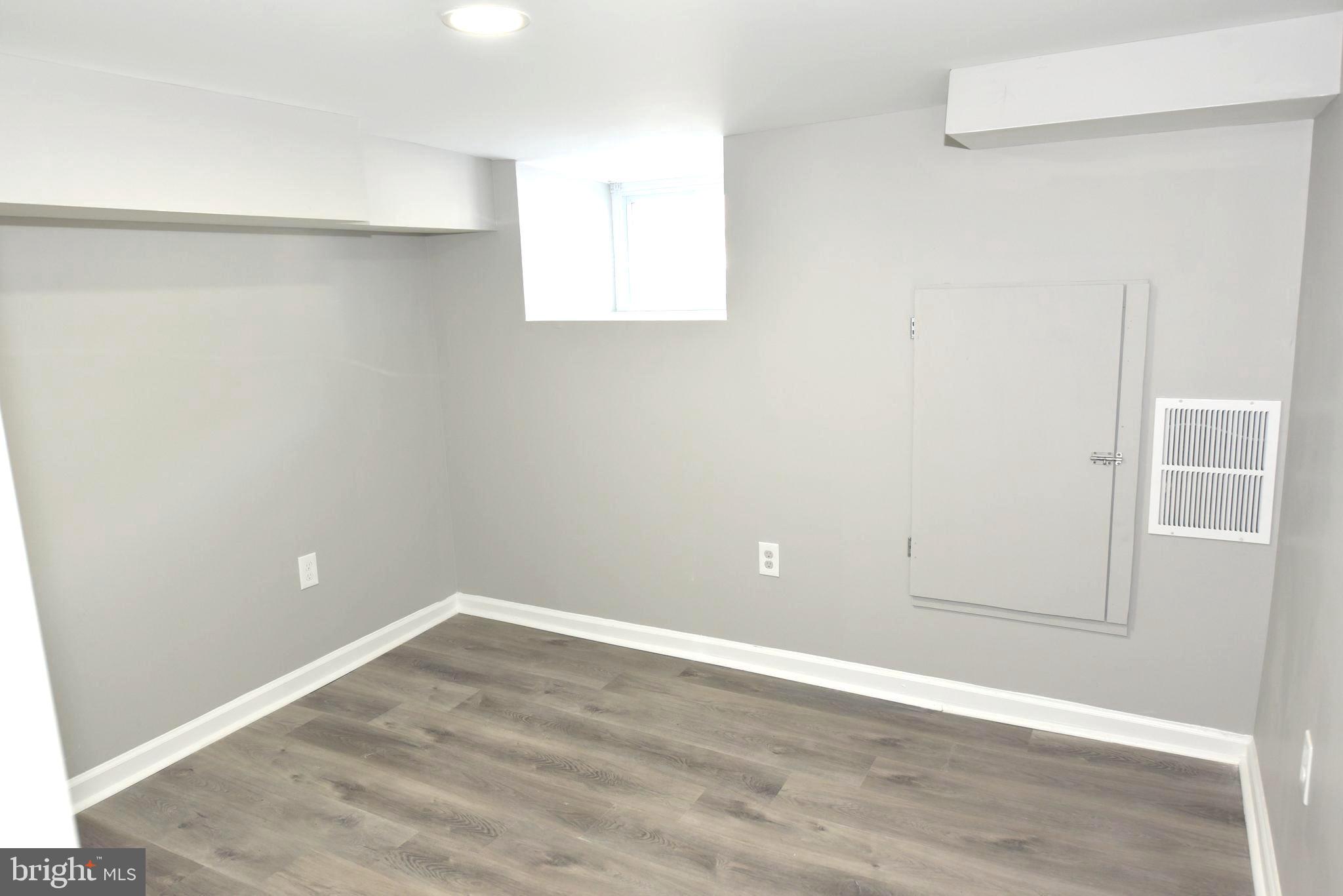 2225 West Baltimore Street Baltimore, MD 21223 - Photo 42 of 46 an empty room with wooden floor and closet