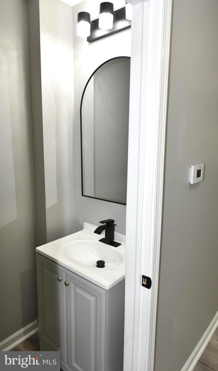 2225 West Baltimore Street Baltimore, MD 21223 - Photo 5 of 46 a bathroom with a sink and mirror